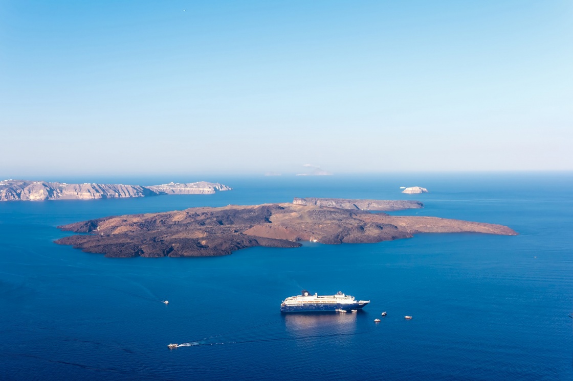 'Nea Kameni volcanic island in Santorini Greece with ships in front photographed from a high point of view' - Santorin